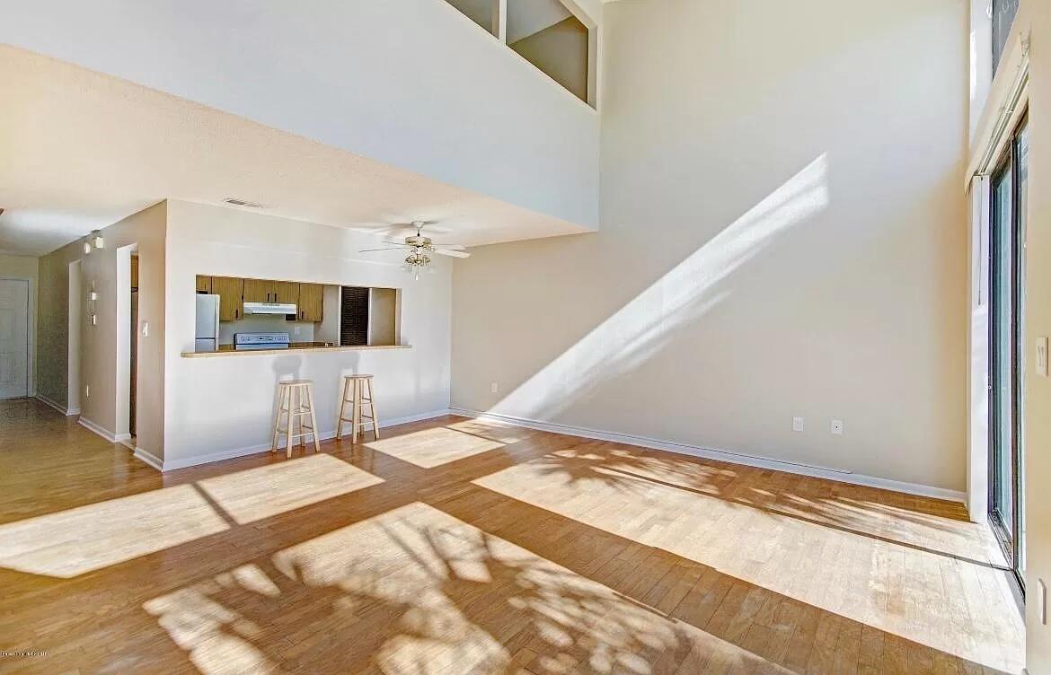 2 Country Club Road, Unit 26 Cocoa Beach, FL 32931 - Photo 5 of 10 a view of a big room with wooden floor and windows