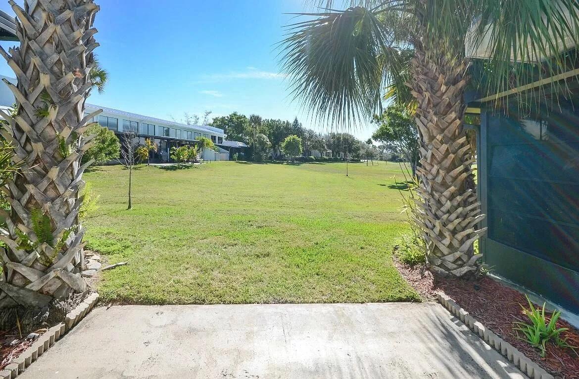 2 Country Club Road, Unit 26 Cocoa Beach, FL 32931 - Photo 7 of 10 a view of swimming pool from a yard