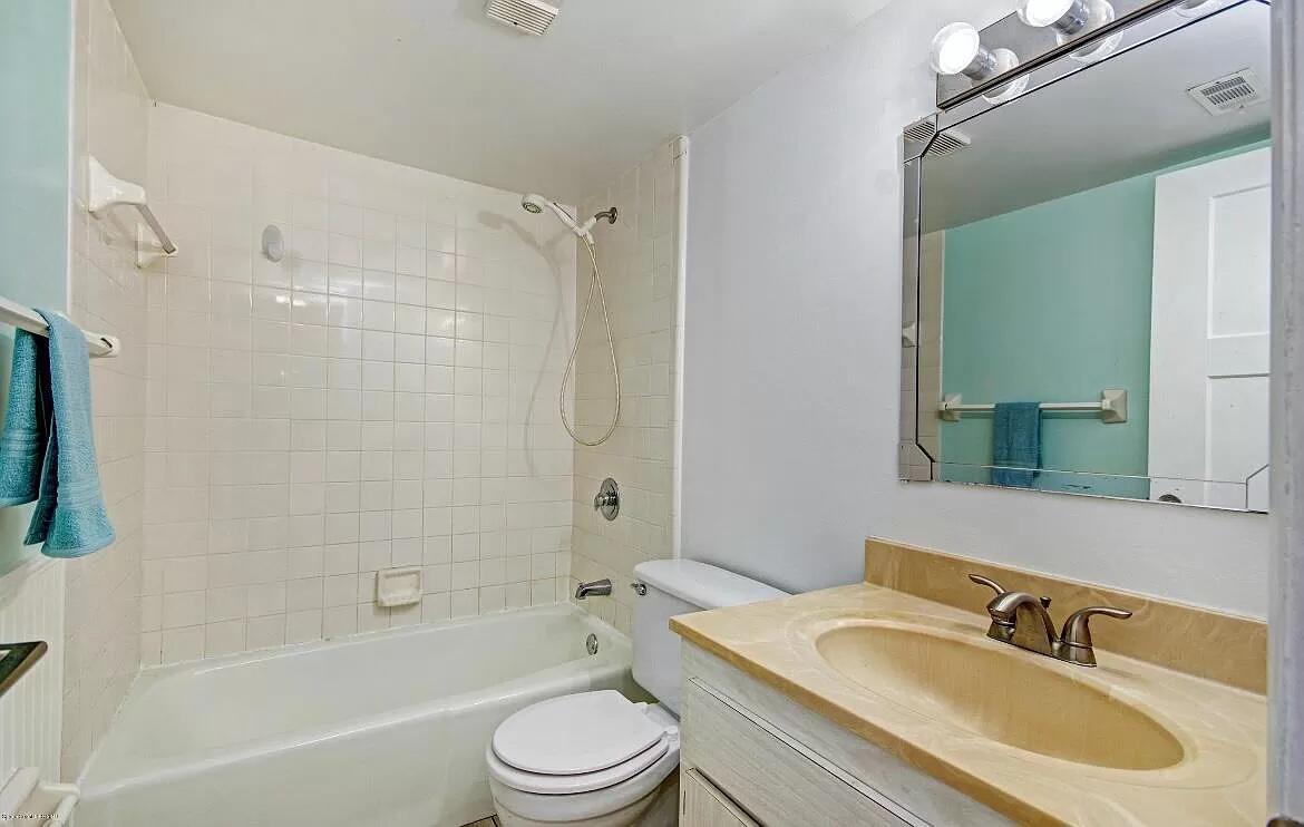 2 Country Club Road, Unit 26 Cocoa Beach, FL 32931 - Photo 10 of 10 a bathroom with a sink toilet a shower and bathtub