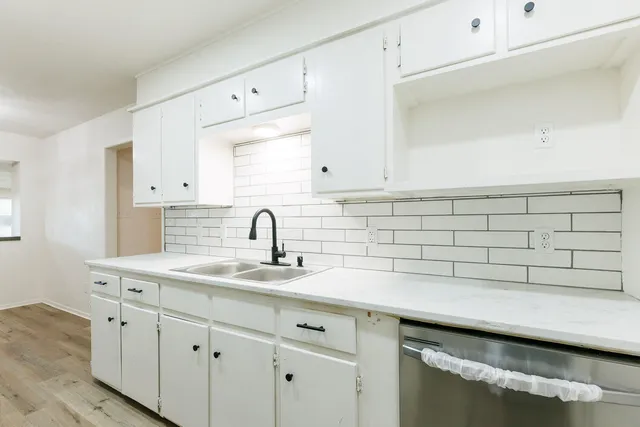 a kitchen with a sink and cabinets