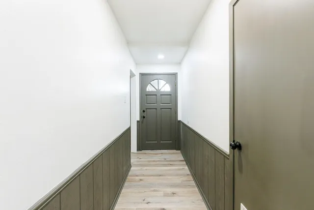 a view of a hallway view with wooden staircase