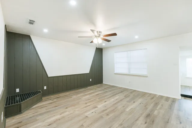 wooden floor in an empty room with a window
