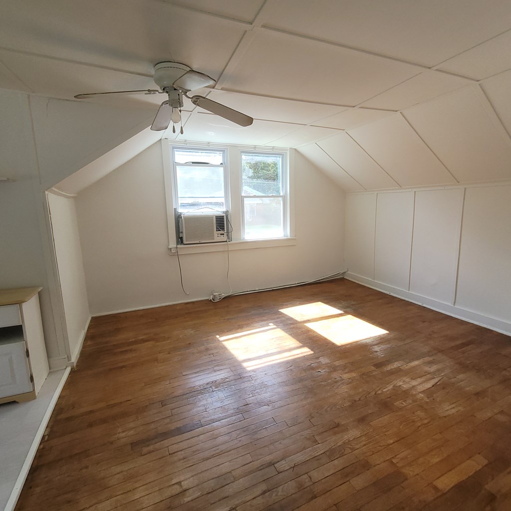 1702 40th Street, Unit C Columbus, GA 31904 - Photo 4 of 10 an empty room with wooden floor and windows