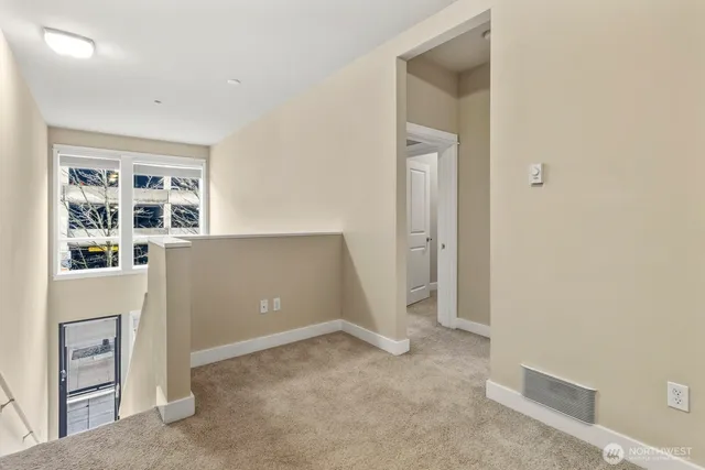 an empty room with windows and closet