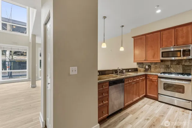 a kitchen with stainless steel appliances granite countertop a stove and a sink