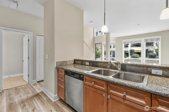 a kitchen with granite countertop a sink and a window