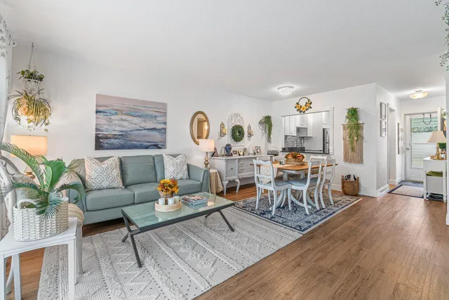 a living room with furniture and wooden floor