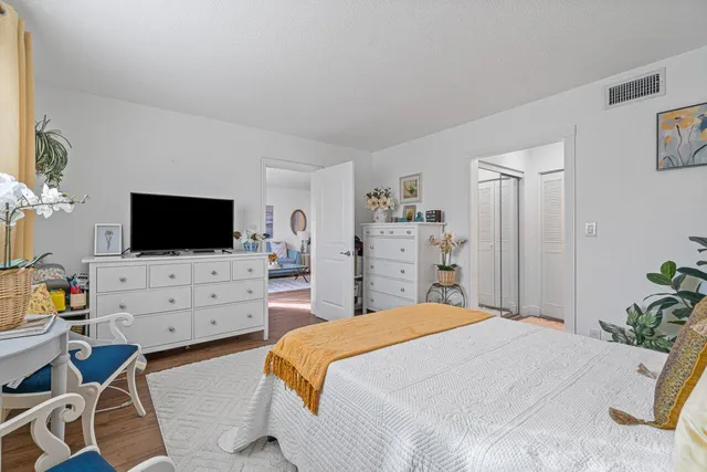 a bedroom with a flat screen tv and a bed