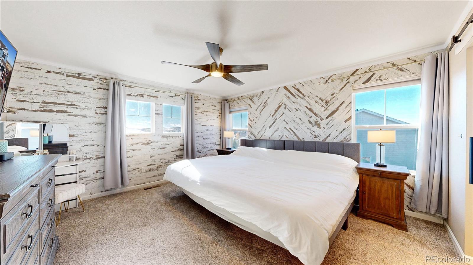 26709 East 1st Place Aurora, CO 80018 - Photo 14 of 50 a bed room with a bed and a dresser