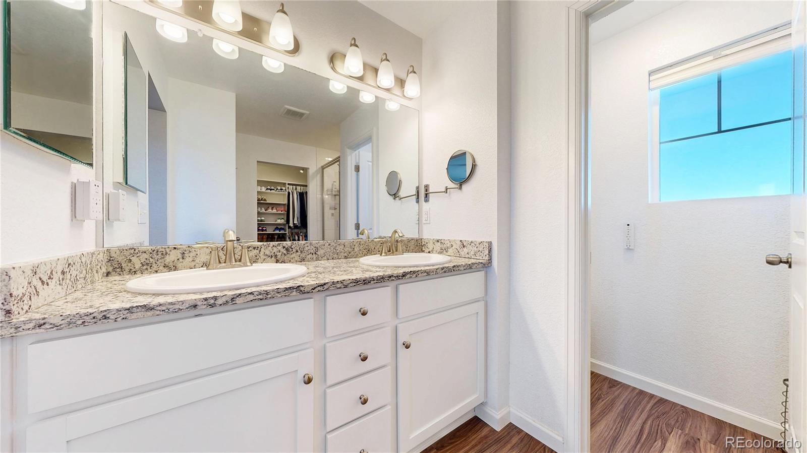 26709 East 1st Place Aurora, CO 80018 - Photo 16 of 50 a bathroom with a granite countertop sink and a mirror