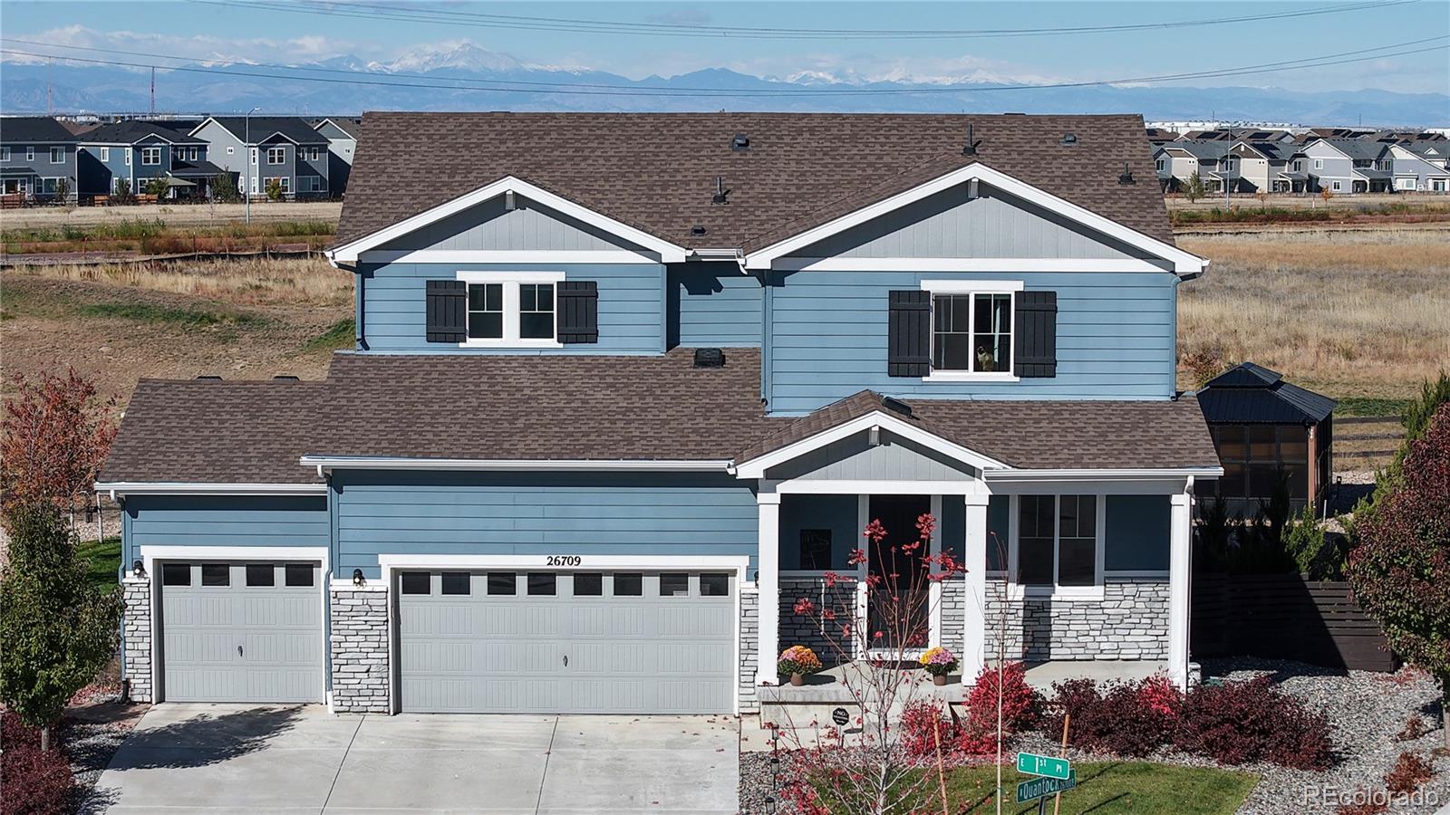 26709 East 1st Place Aurora, CO 80018 - Photo 2 of 50 a front view of a house with a yard