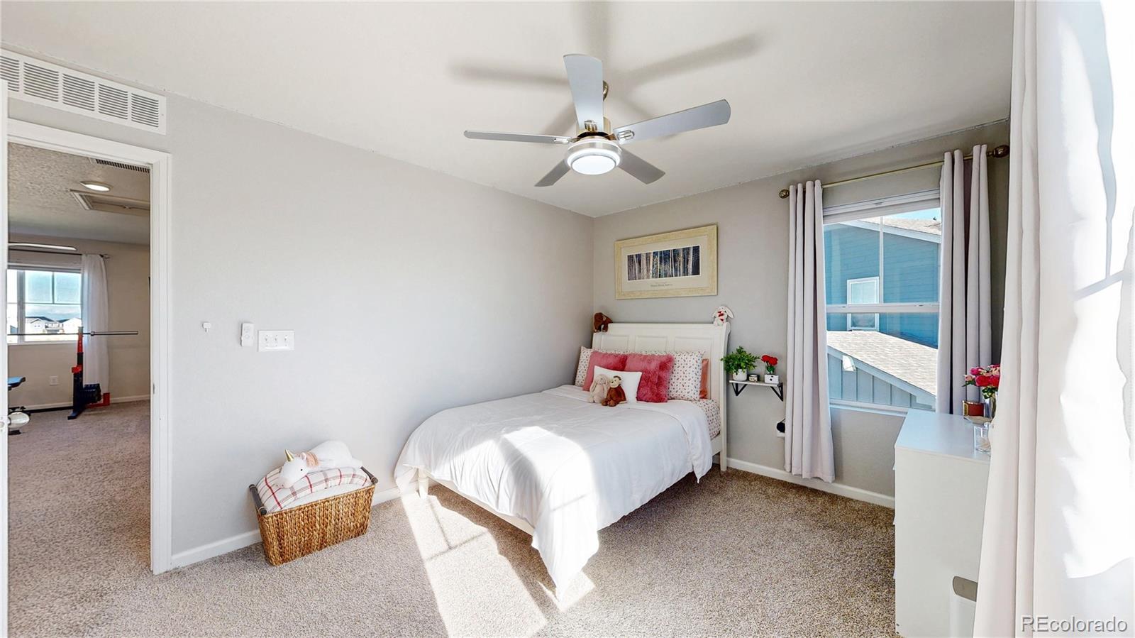 26709 East 1st Place Aurora, CO 80018 - Photo 21 of 50 a bedroom with a bed and a chandelier