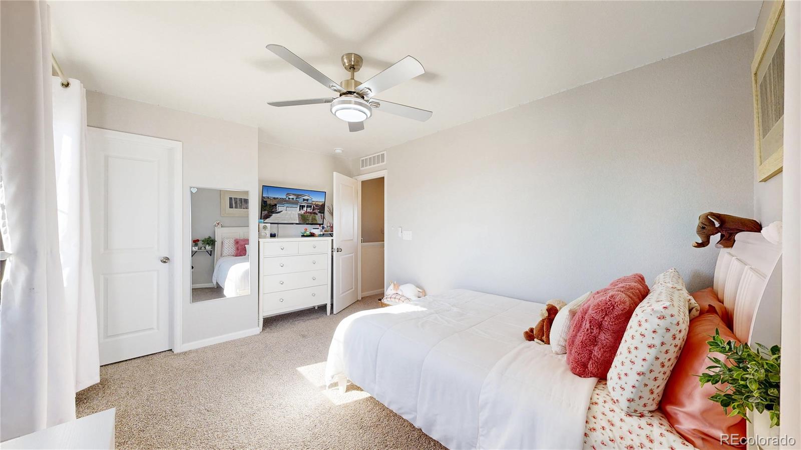 26709 East 1st Place Aurora, CO 80018 - Photo 22 of 50 a bedroom with a bed and a chandelier