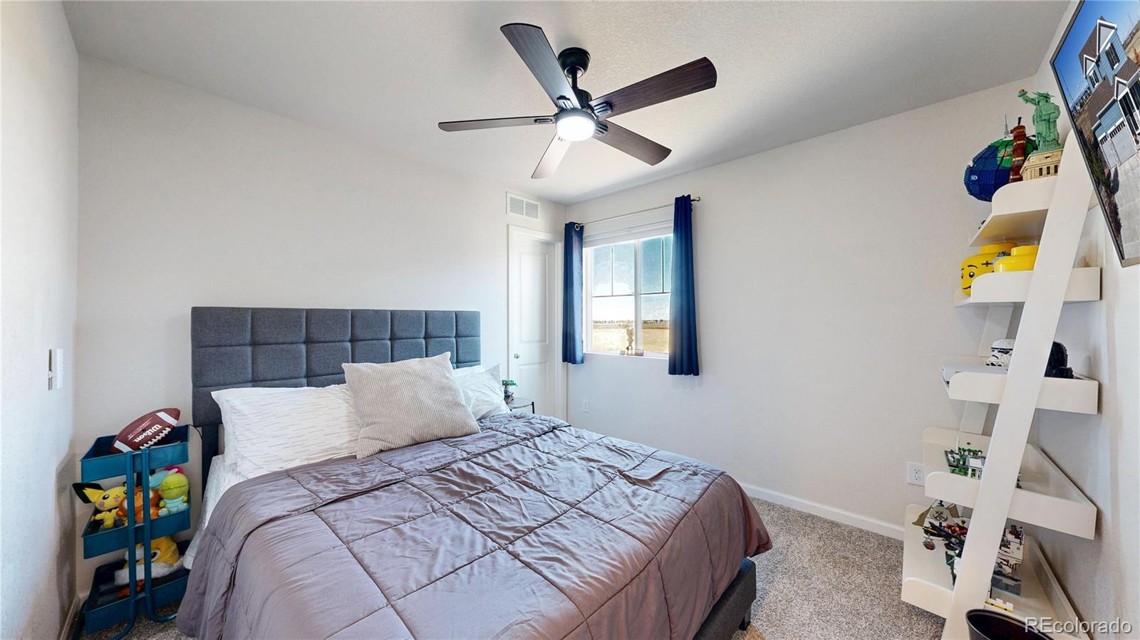 26709 East 1st Place Aurora, CO 80018 - Photo 24 of 50 a bedroom with a bed and a chandelier