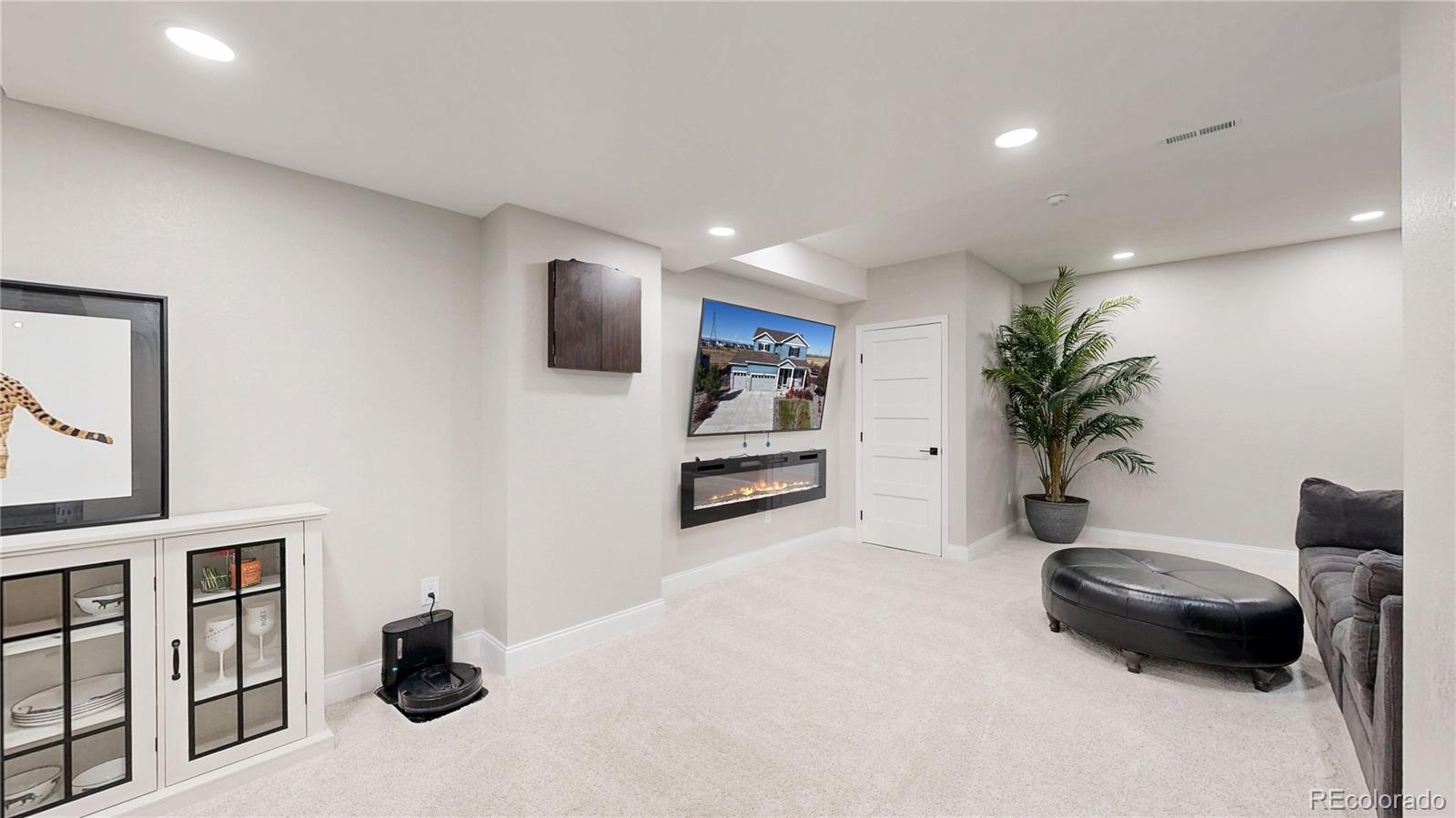 26709 East 1st Place Aurora, CO 80018 - Photo 27 of 50 a living room with furniture and a flat screen tv