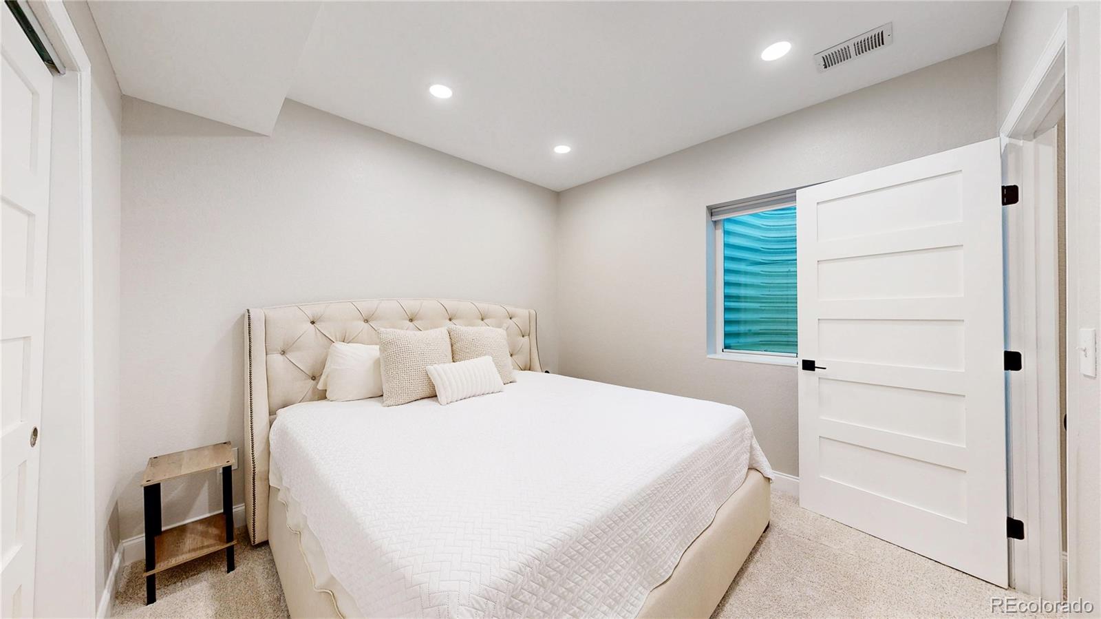 26709 East 1st Place Aurora, CO 80018 - Photo 30 of 50 a bedroom with a bed and a window