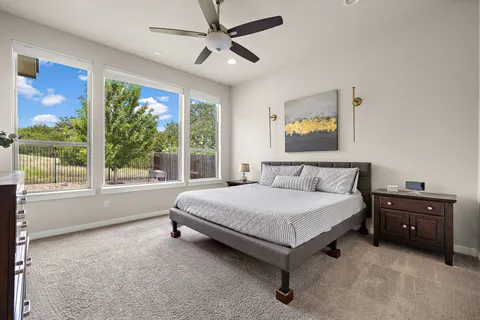 a spacious bedroom with a bed and a large window