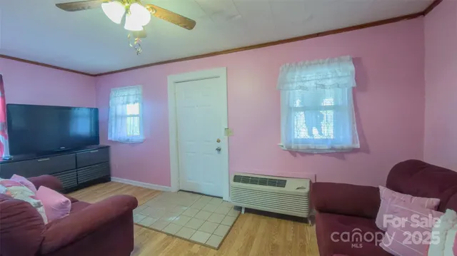 a living room with furniture and wooden floor