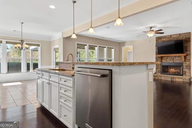 a view of a room with a large window and chandelier