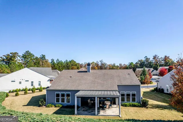 an aerial view of a house with a swimming pool