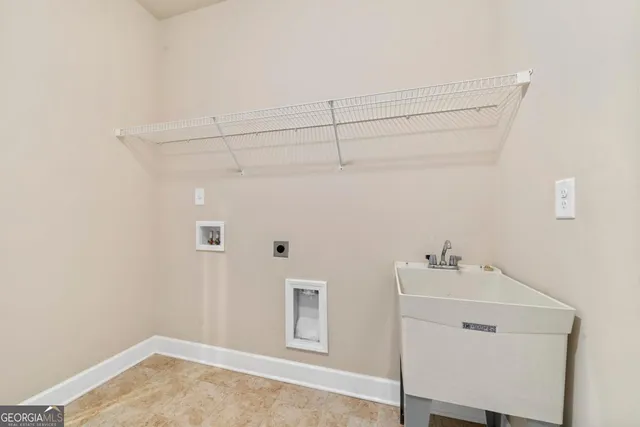 an empty room with chandelier fan and windows