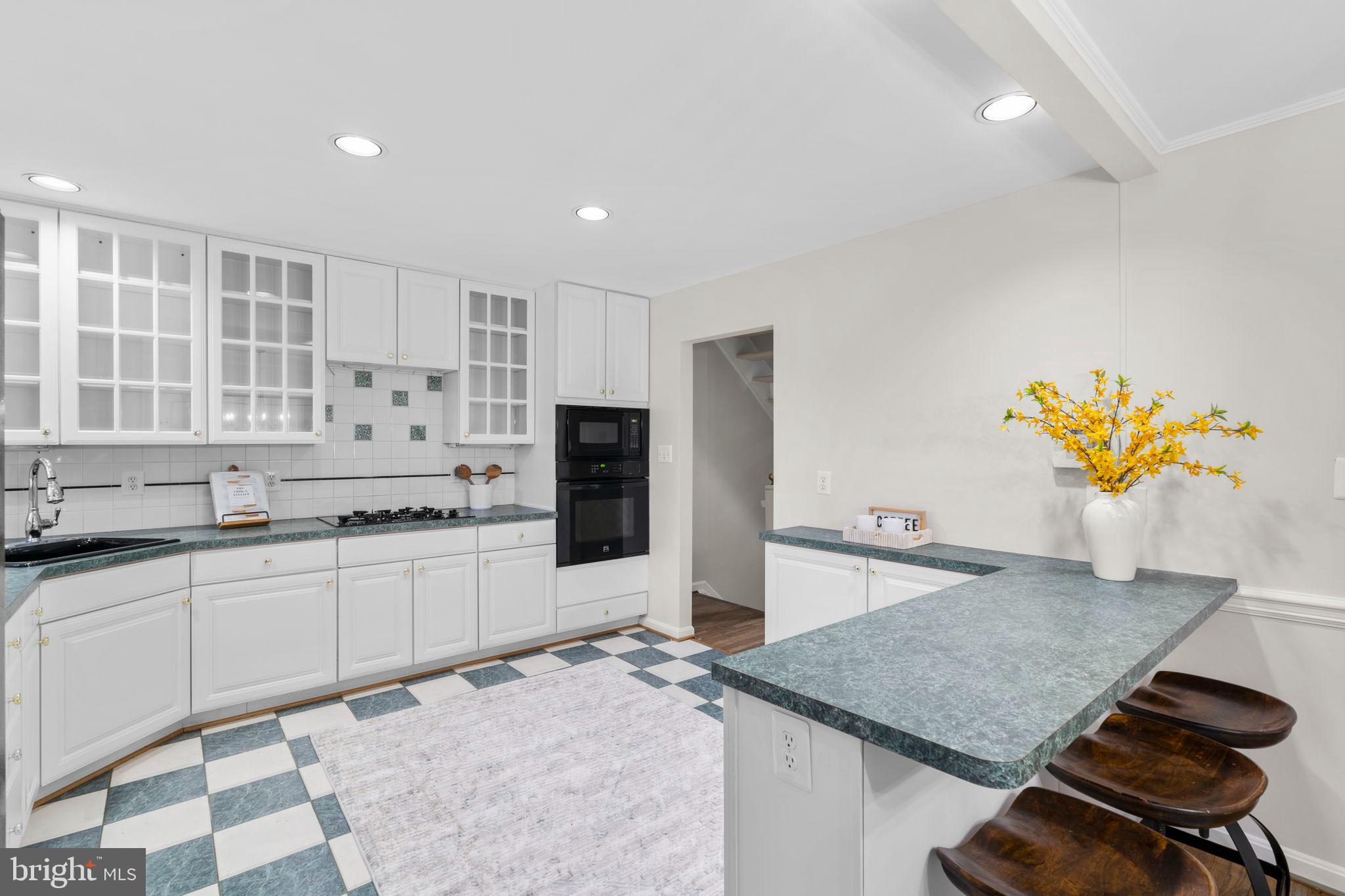 2126 Golf Course Drive Reston, VA 20191 - Photo 13 of 48 a kitchen with stainless steel appliances granite countertop a sink and a stove