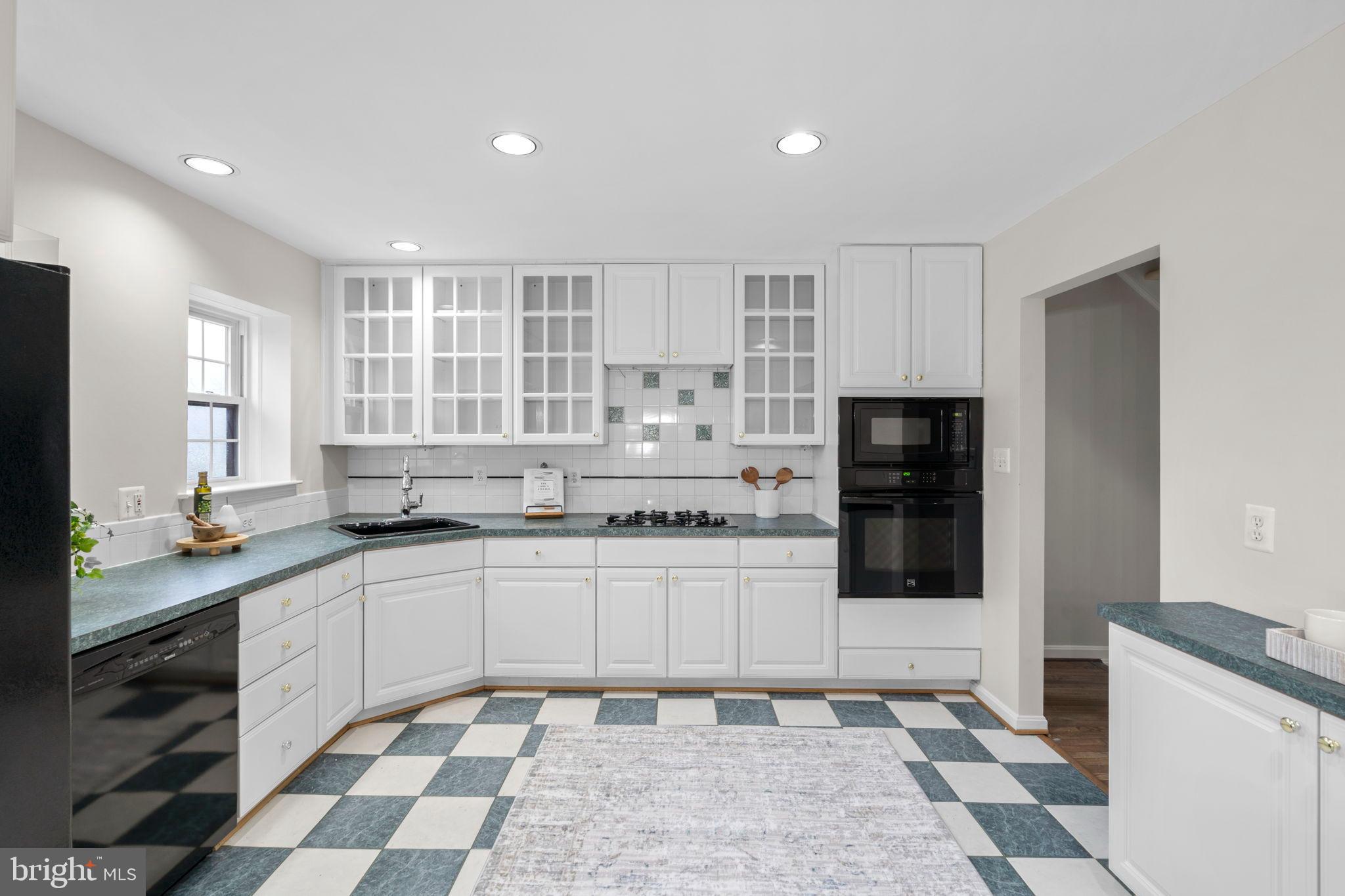 2126 Golf Course Drive Reston, VA 20191 - Photo 14 of 48 a kitchen with stainless steel appliances granite countertop a sink and a stove