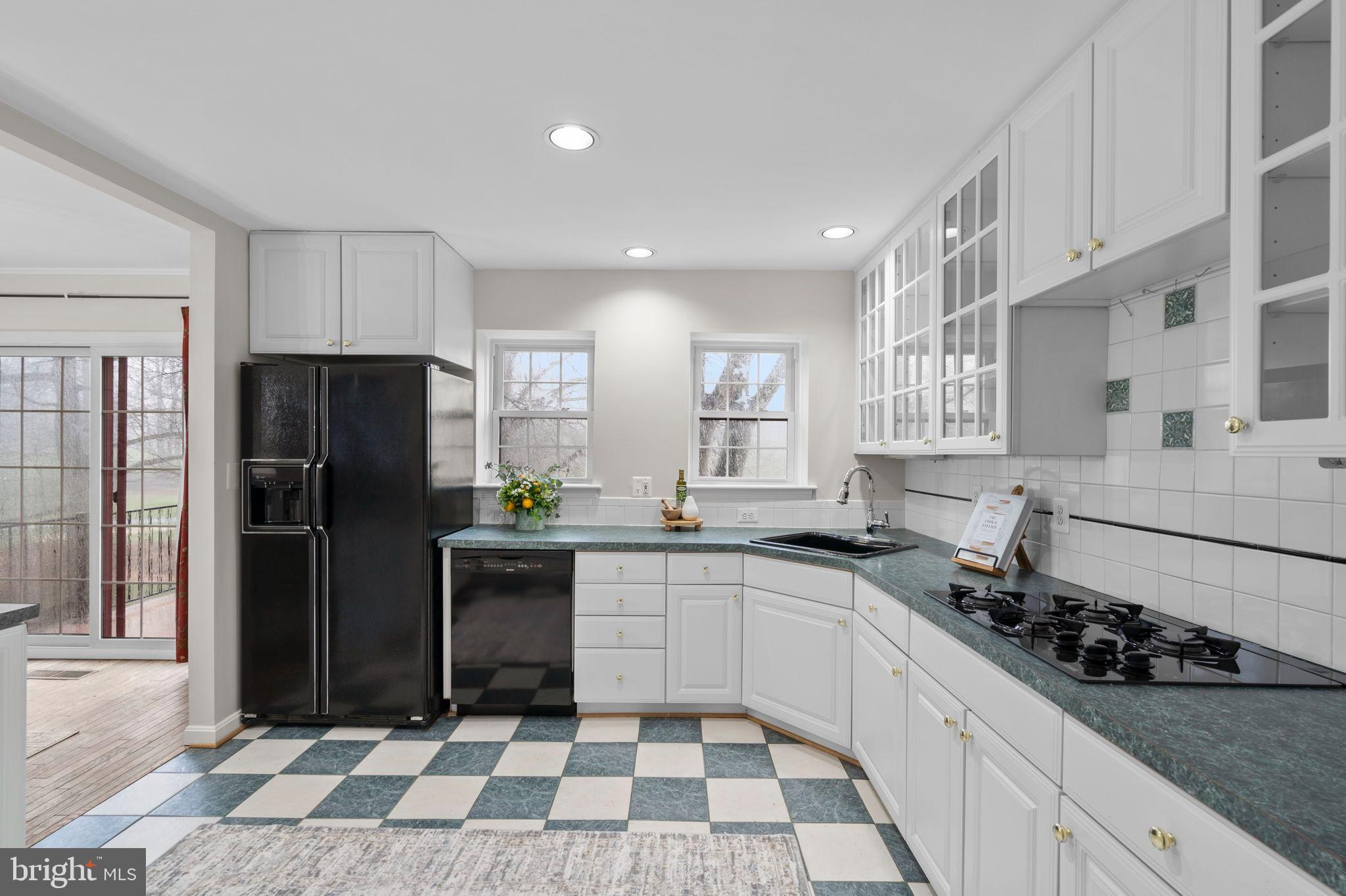 2126 Golf Course Drive Reston, VA 20191 - Photo 16 of 48 a kitchen with a sink a refrigerator and cabinets