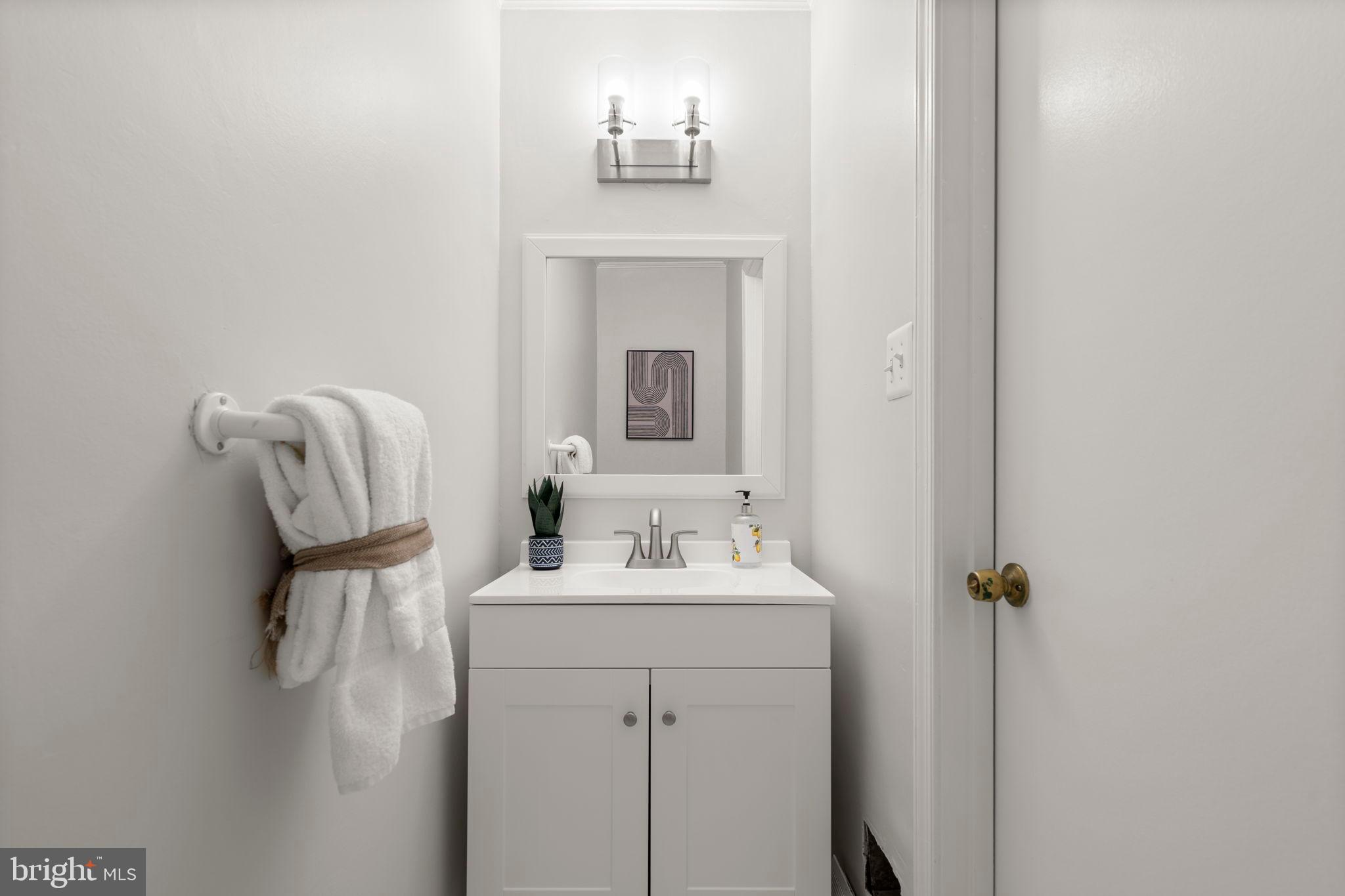 2126 Golf Course Drive Reston, VA 20191 - Photo 18 of 48 a bathroom with a sink vanity and mirror
