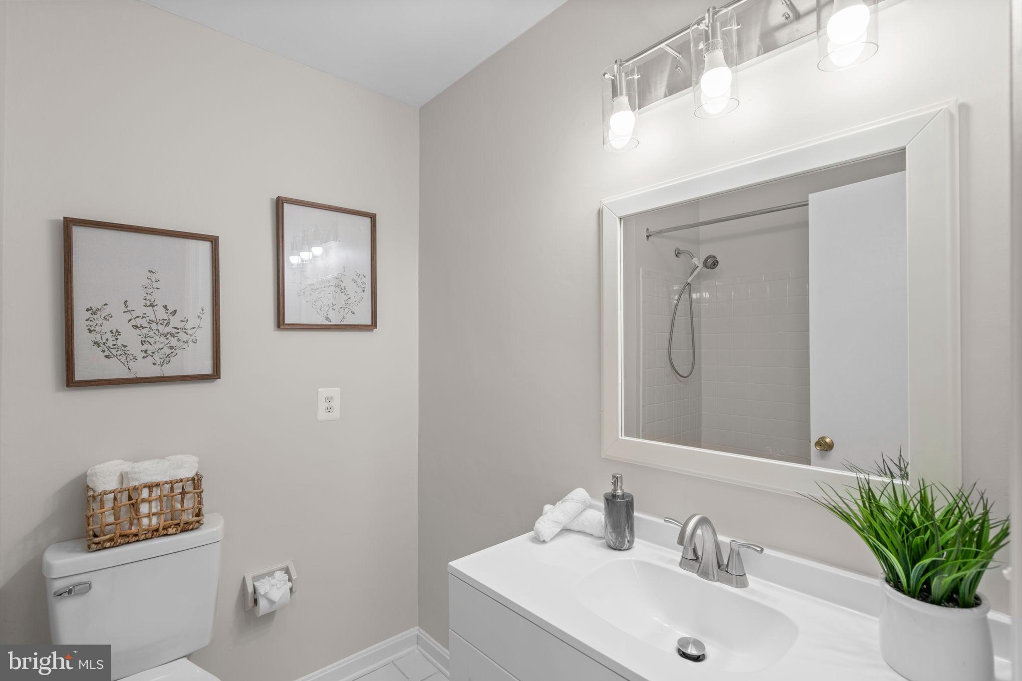 2126 Golf Course Drive Reston, VA 20191 - Photo 24 of 48 a bathroom with a sink mirror and toilet