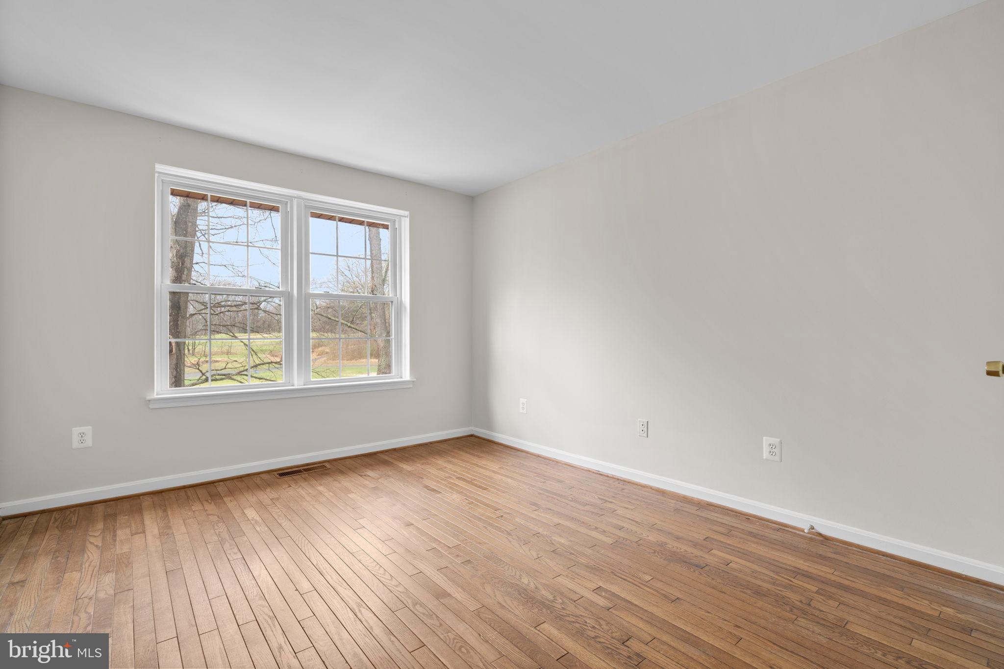 2126 Golf Course Drive Reston, VA 20191 - Photo 27 of 48 an empty room with wooden floor and windows