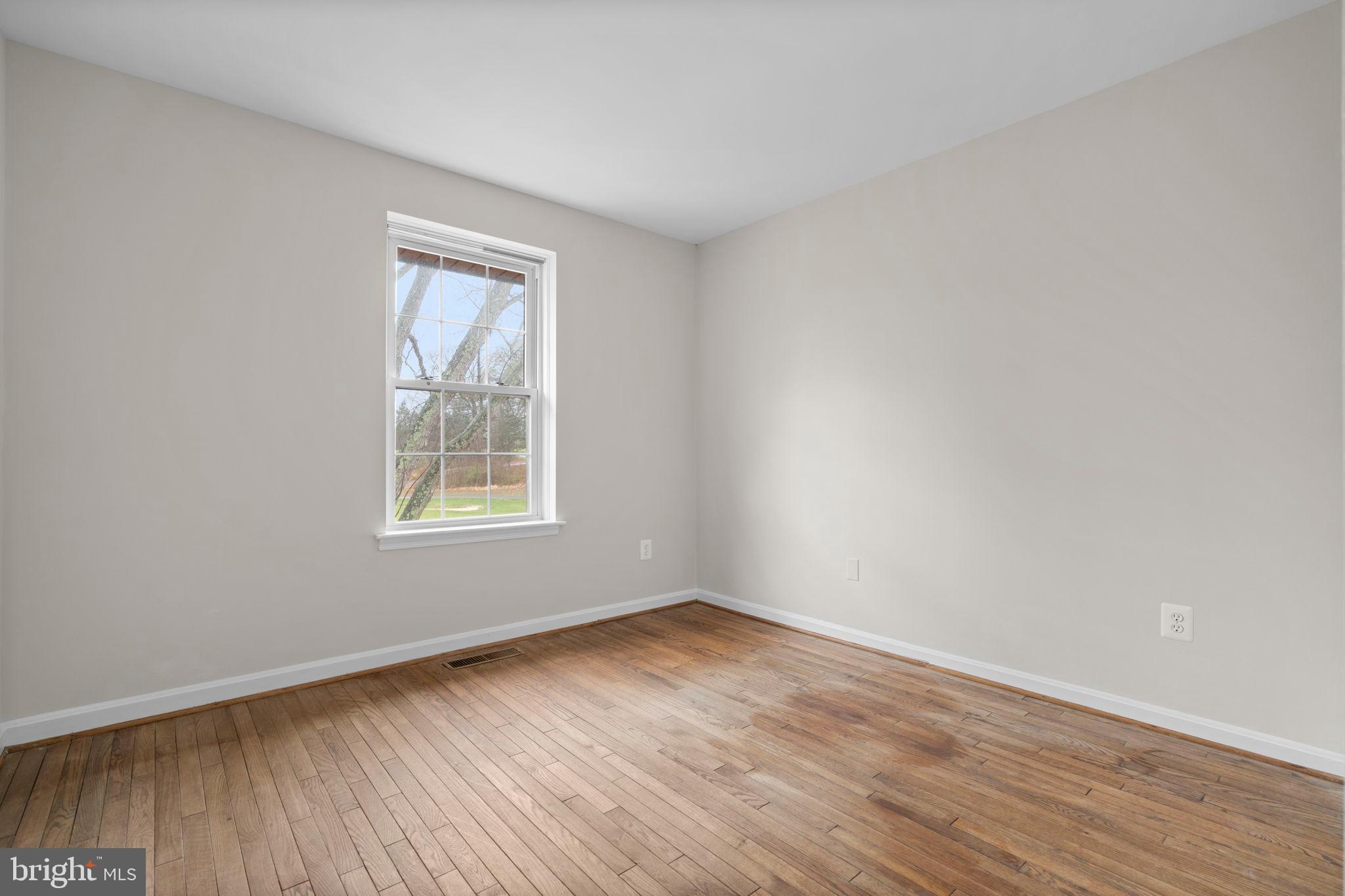 2126 Golf Course Drive Reston, VA 20191 - Photo 29 of 48 an empty room with wooden floor and windows