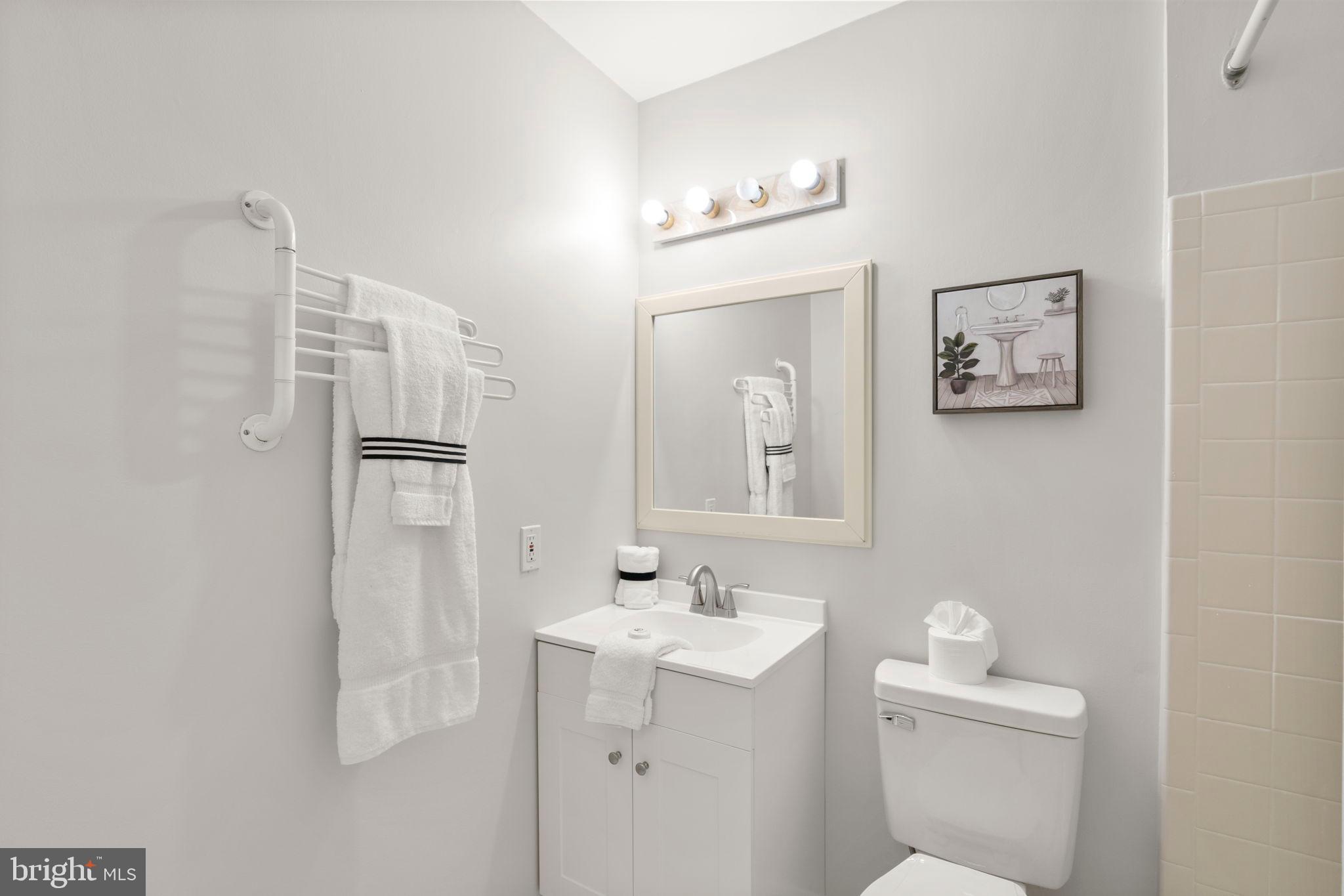 2126 Golf Course Drive Reston, VA 20191 - Photo 31 of 48 a bathroom with a toilet sink and mirror