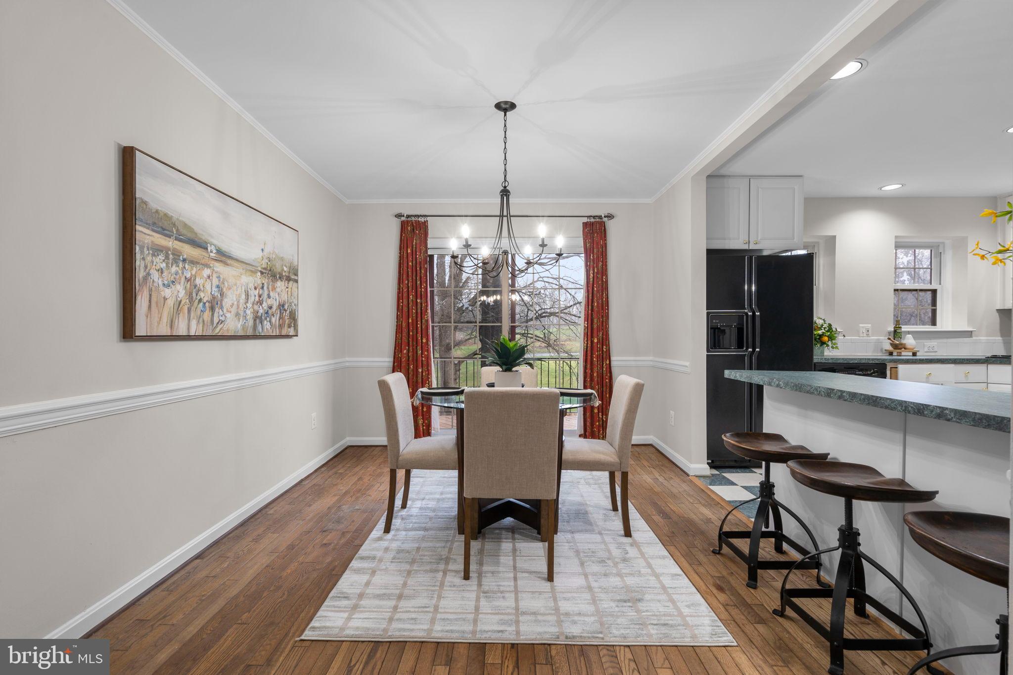 2126 Golf Course Drive Reston, VA 20191 - Photo 10 of 48 a dining room with furniture a rug a window and wooden floor