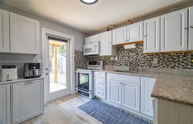 a view of kitchen with furniture and wooden floor