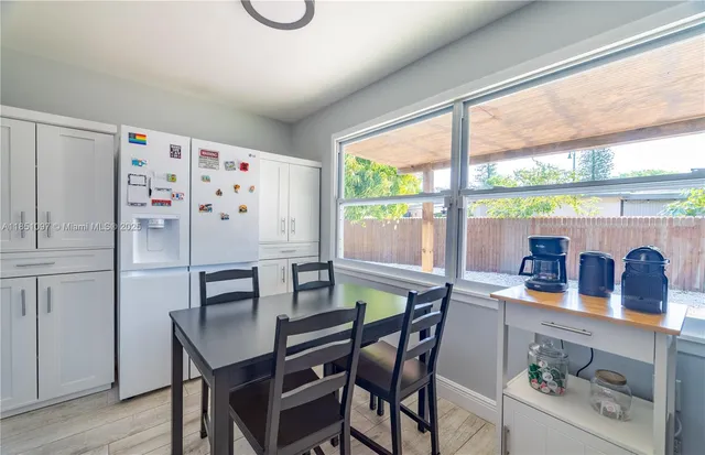 a dining room with furniture and window
