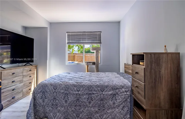 a bedroom with a bed and flat screen tv