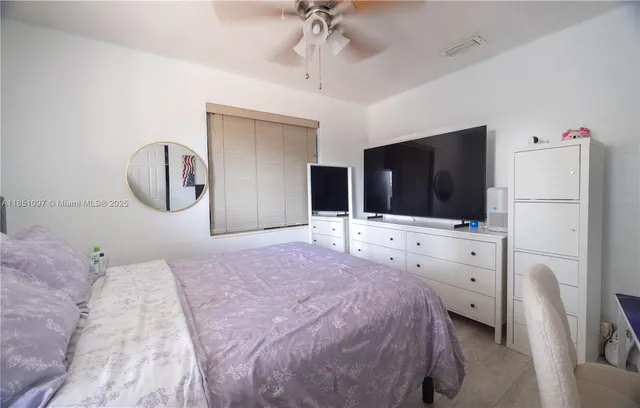 a bedroom with bed and wooden floor