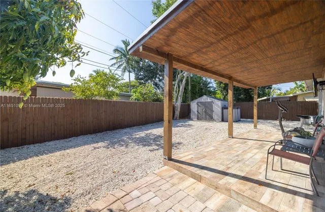 a view of a house with a tree in the background