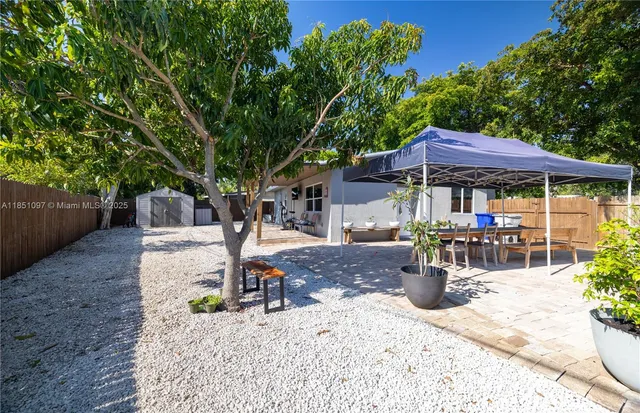 a backyard of a house with yard and outdoor seating