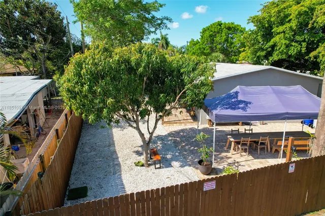 an aerial view of a house with a yard and garden