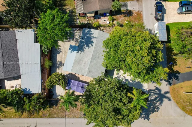 a view of a backyard with large trees