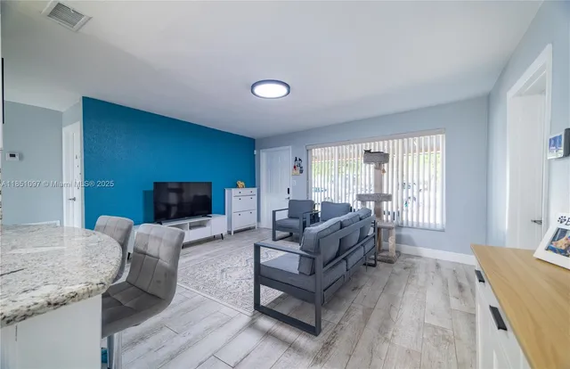 a living room with furniture and a flat screen tv