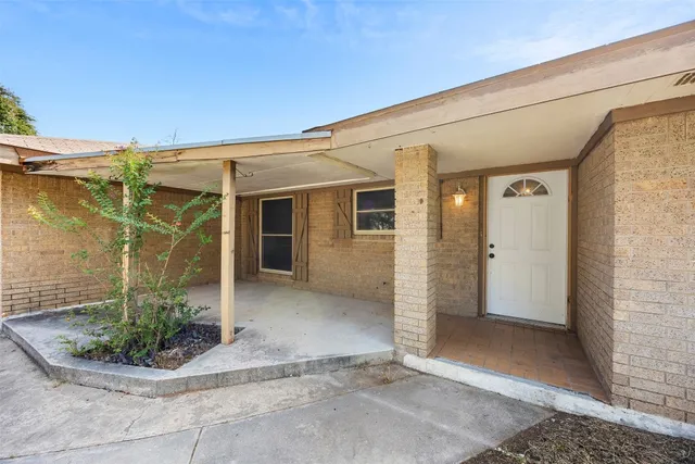 a view of a house with potted plants