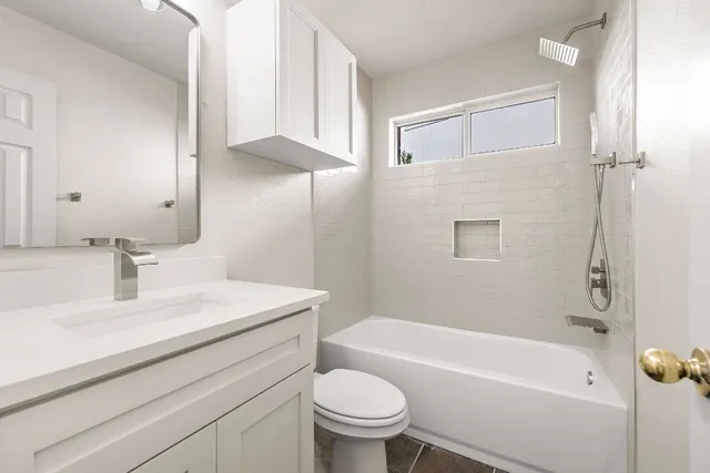 a bathroom with a sink a toilet and a bathtub