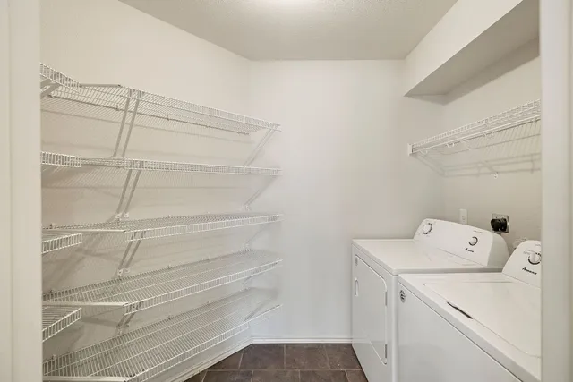 a view of storage and utility room with washer and dryer