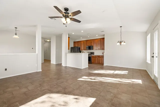 a view of a kitchen with a sink and a refrigerator