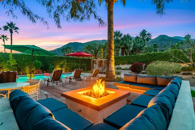 a view of swimming pool with seating area and barbeque oven