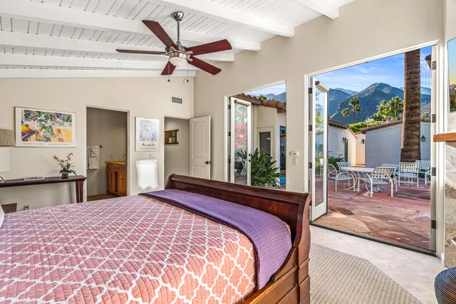 a bathroom with a granite countertop double vanity sink and mirror