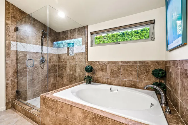 a bedroom with a bed couch and ceiling fan